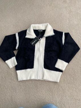 New. Oliver. O, Black and White Fuzzy Zip-Up cardigan in size medium.